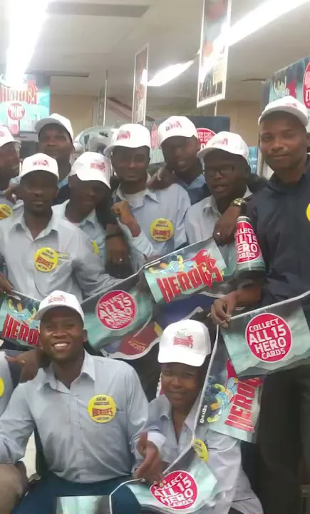 A promoter in a Pick n Pay store holding Heroes cards