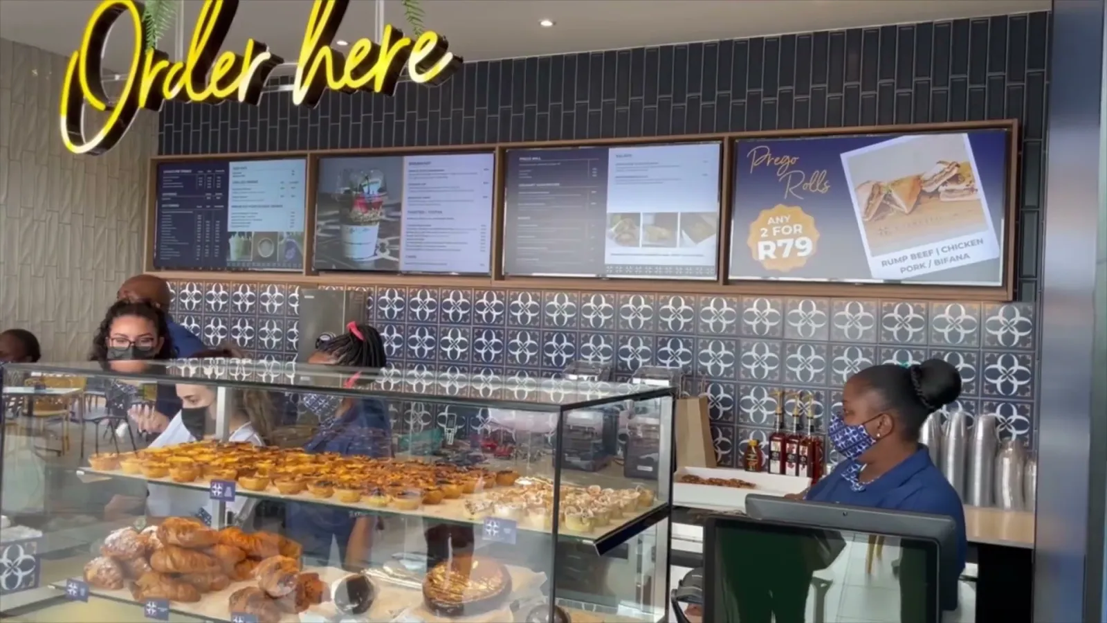 Order-point screens above a bakery counter