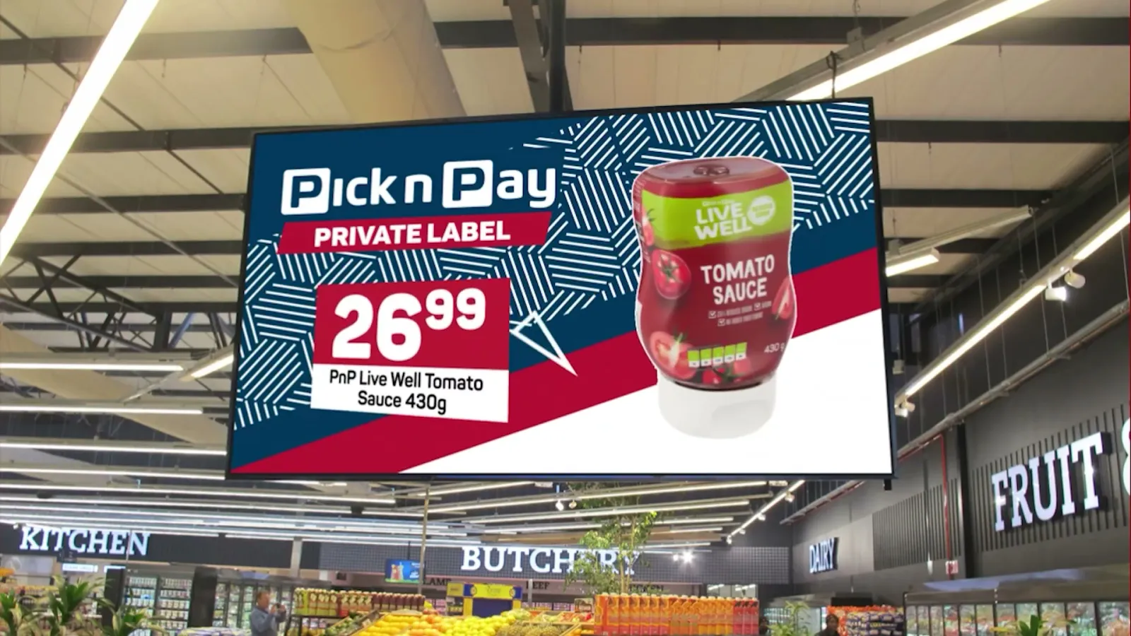 A digital screen hanging above a Pick n Pay aisle showing a private label promotion