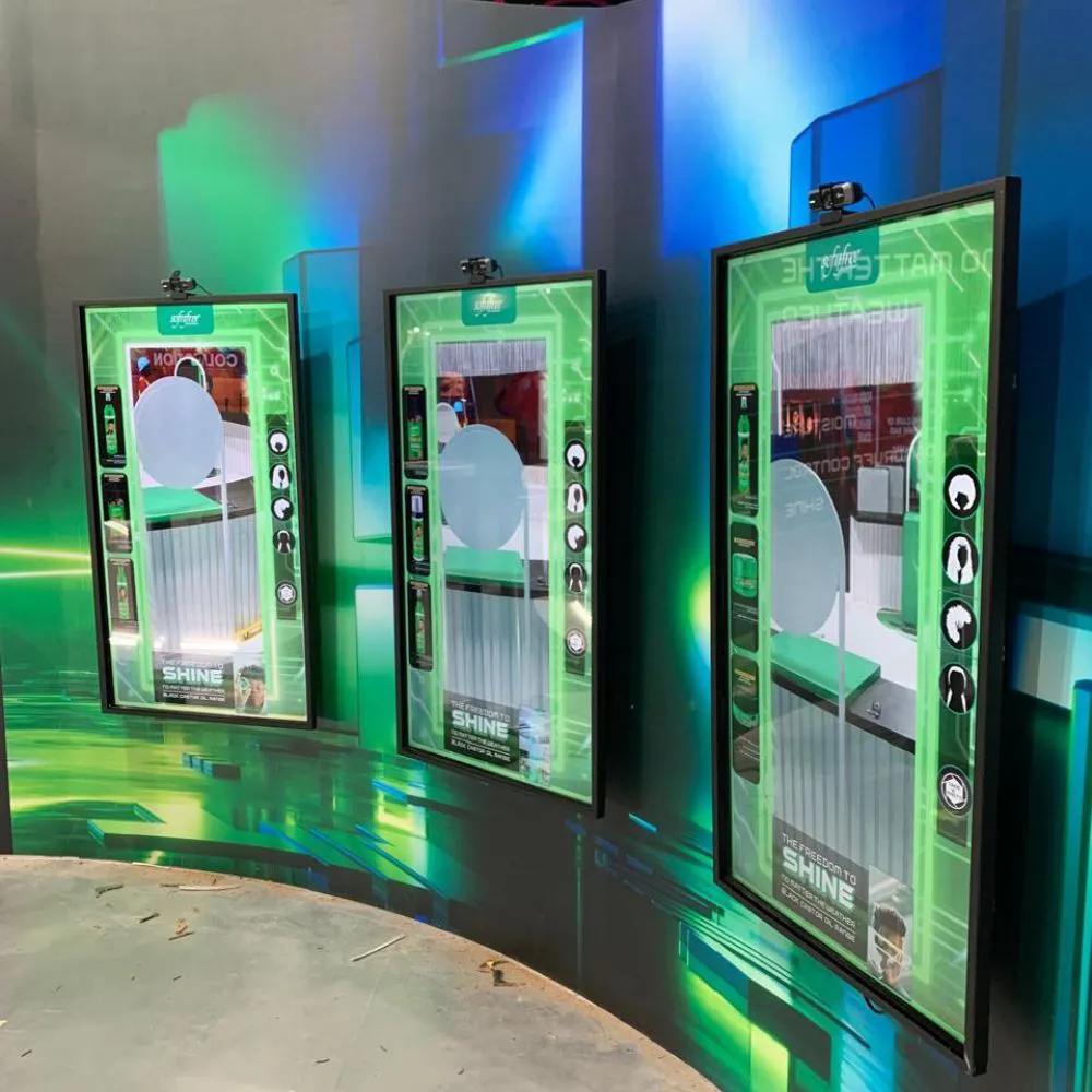 Three Magic Mirror screens standing in a green-lit room