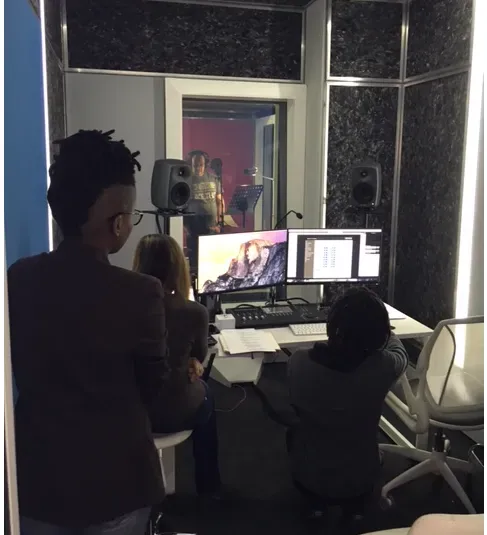 A producer at the desk in the studio control room
