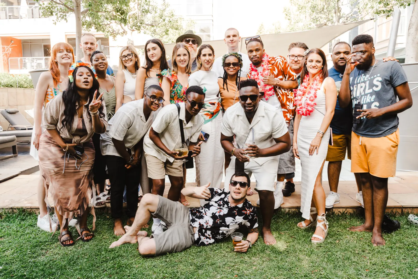 The Magos Media team together on a lawn